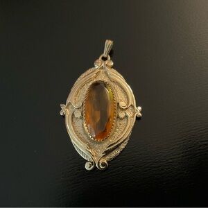 Elegant Gold Pendant with Amber Stone